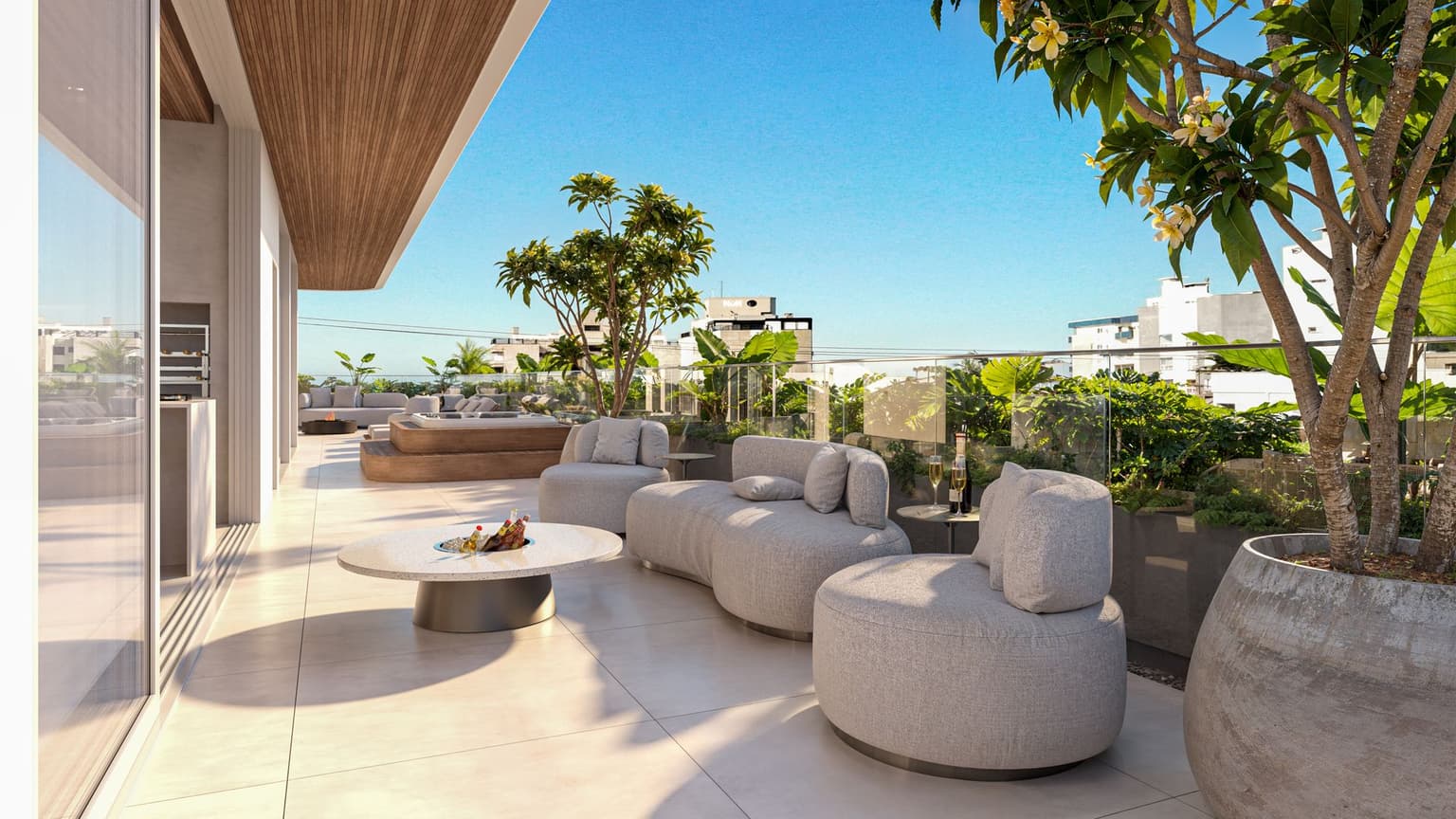 Render do terraço de um apartamento garden, com sofás externos, mesa de centro e vegetação